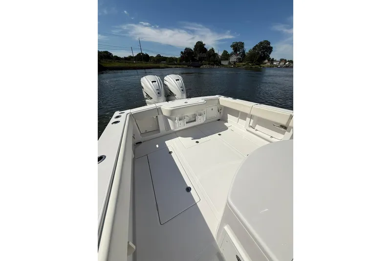 Slide: The Image of 2021 Jupiter 38 HFS boat with dual engines on a calm waterway. - 33