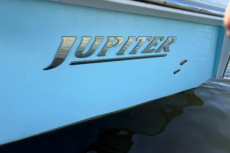 Slide: The Image of 2021 Jupiter 38 HFS boat with metallic logo on light blue hull. - 40