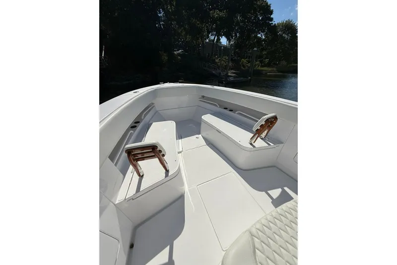 Slide: The Image of 2021 Jupiter 38 HFS boat interior with white seating and wooden accents. - 41