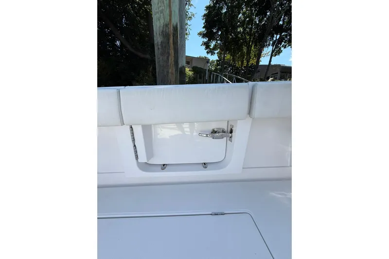 Slide: The Image of 2021 Jupiter 38 HFS boat interior, featuring a sleek white design and cushioned seating. - 6