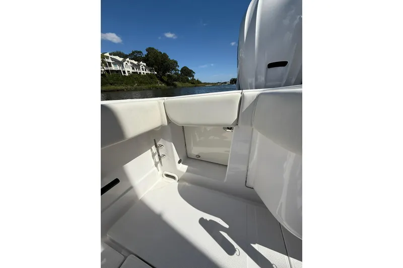 Slide: The Image of 2021 Jupiter 38 HFS boat interior with white seating, near waterfront homes. - 7