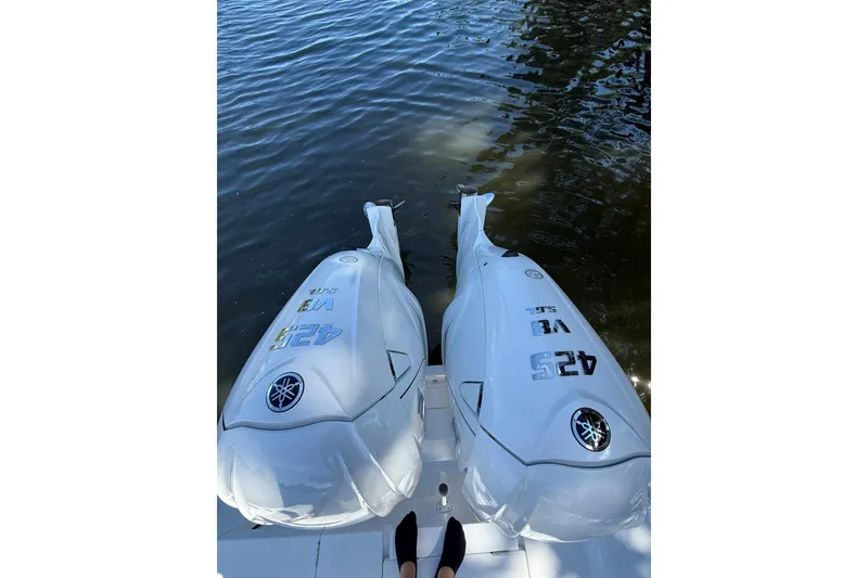 Slide: The Image of Twin Yamaha 425 V8 engines on a 2021 Jupiter 38 HFS boat by the water. - 9
