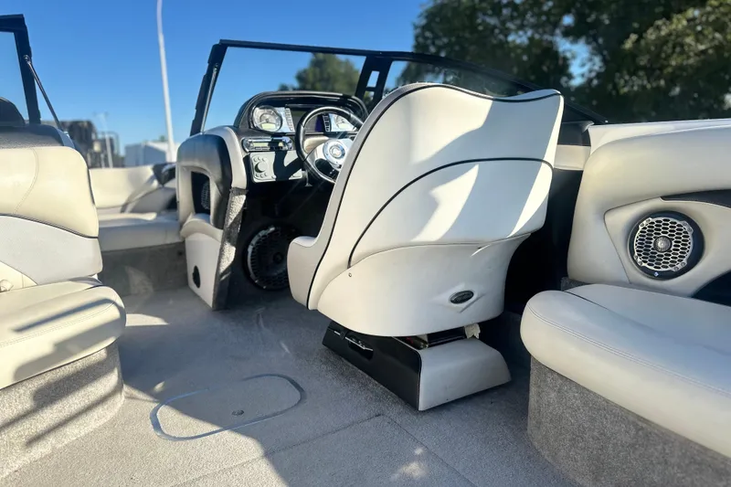 Slide: The Image of 2008 Malibu Boats 23 LSV interior with white seating and dashboard, featuring modern controls. - 10