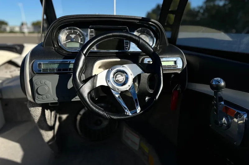 Slide: The Image of 2008 Malibu Boats 23 LSV dashboard with steering wheel and control panel. - 11