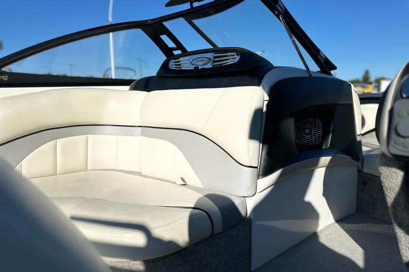 Slide: The Image of Interior of a 2008 Malibu Boats 23 LSV, featuring white leather seating and speaker system. - 12