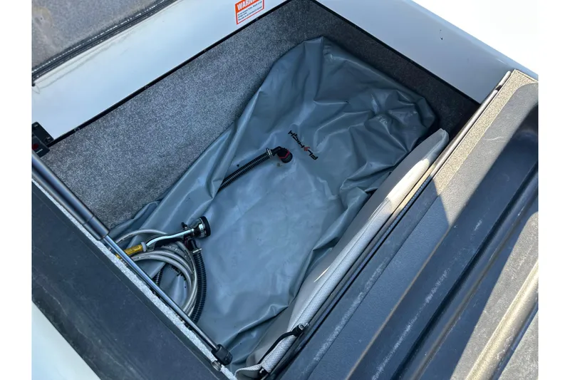 Slide: The Image of Storage compartment of a 2008 Malibu Boats 23 LSV with ballast bag and hoses. - 15