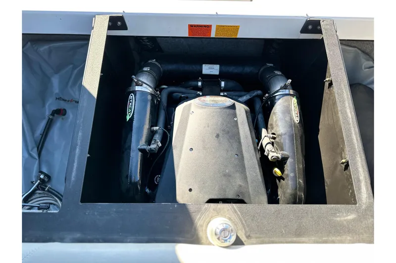 Slide: The Image of Engine compartment of a 2008 Malibu Boats 23 LSV, showcasing detailed components. - 16