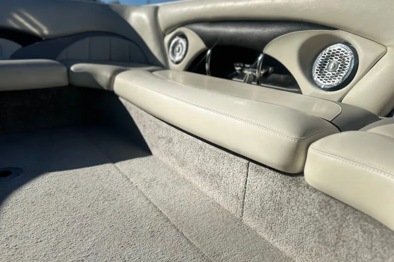 Slide: The Image of 2008 Malibu Boats 23 LSV interior with beige seating and built-in speakers. - 7