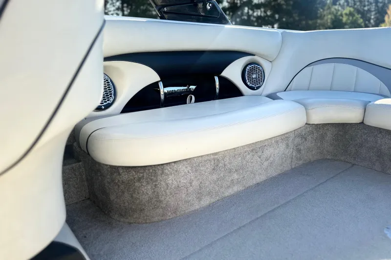 Slide: The Image of 2008 Malibu Boats 23 LSV interior with white seating and built-in speakers. - 9