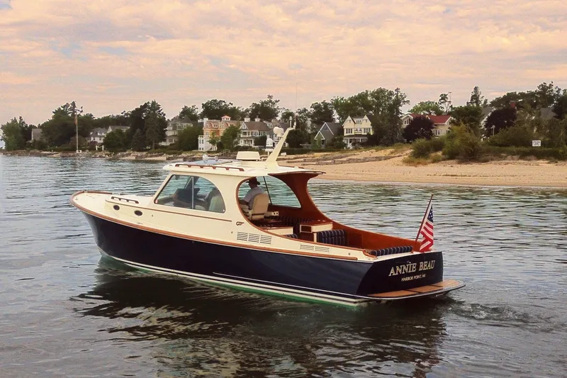 The Image of 2011 Hinckley Picnic Boat 37 MKIII cruising near a scenic shoreline. - 0