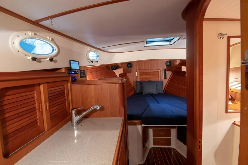 Slide: The Image of Luxurious wooden interior of 2011 Hinckley Picnic Boat 37 MKIII with sink and storage. - 10