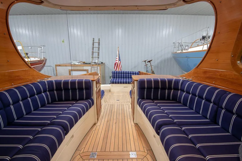 Slide: The Image of Hinckley Picnic Boat 37 MKIII, 2011, docked with American flag, elegant design, blue hull. - 13