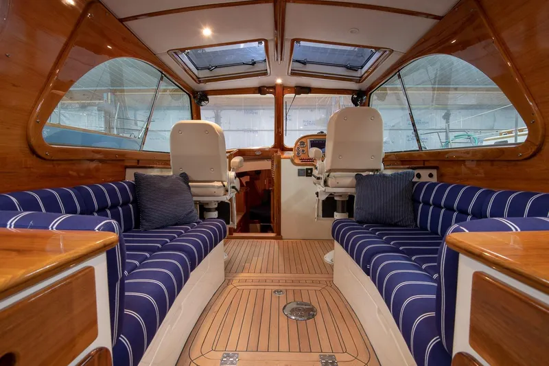 Slide: The Image of Hinckley Picnic Boat 37 MKIII 2011 with striped seating, docked at marina during sunset. - 3