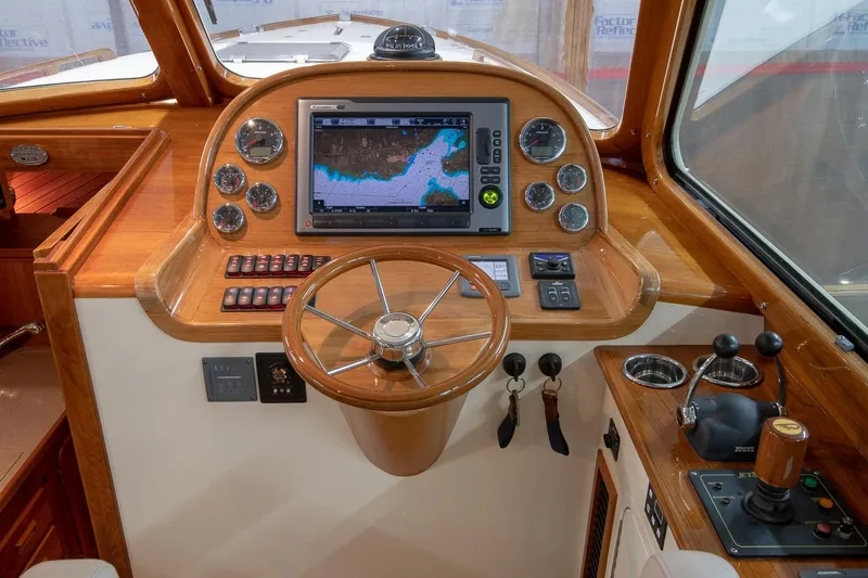 Slide: The Image of Interior of 2011 Hinckley Picnic Boat 37 MKIII with elegant seating and wooden finishes. - 7