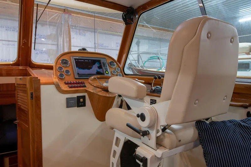 Slide: The Image of Helm of 2011 Hinckley Picnic Boat 37 MKIII with luxurious seating and navigation controls. - 6