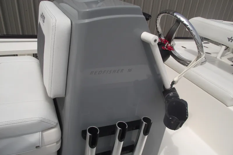 Slide: The Image of 2024 Hewes Redfisher 16 boat console with steering wheel and rod holders. - 14