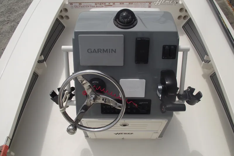Slide: The Image of 2024 Hewes Redfisher 16 boat console with Garmin navigation and Yamaha controls. - 15