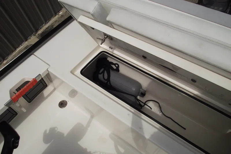 Slide: The Image of 2024 Hewes Redfisher 16 boat storage compartment with fender and rope. - 20