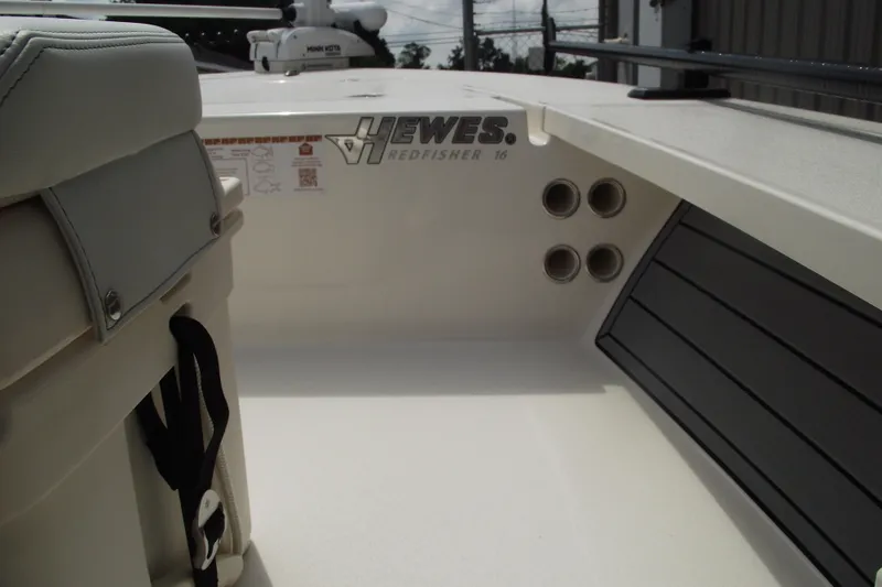 Slide: The Image of 2024 Hewes Redfisher 16 boat interior with seating and rod holders. - 21