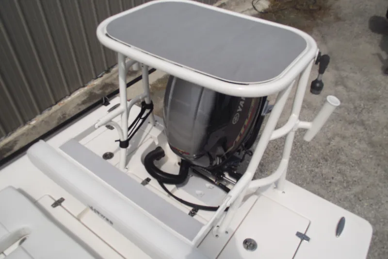 Slide: The Image of 2024 Hewes Redfisher 16 boat with Yamaha outboard motor and fishing rod holders. - 23