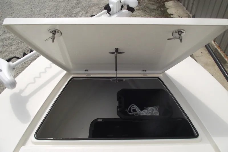 Slide: The Image of 2024 Hewes Redfisher 16 boat storage compartment with open hatch and rope inside. - 9