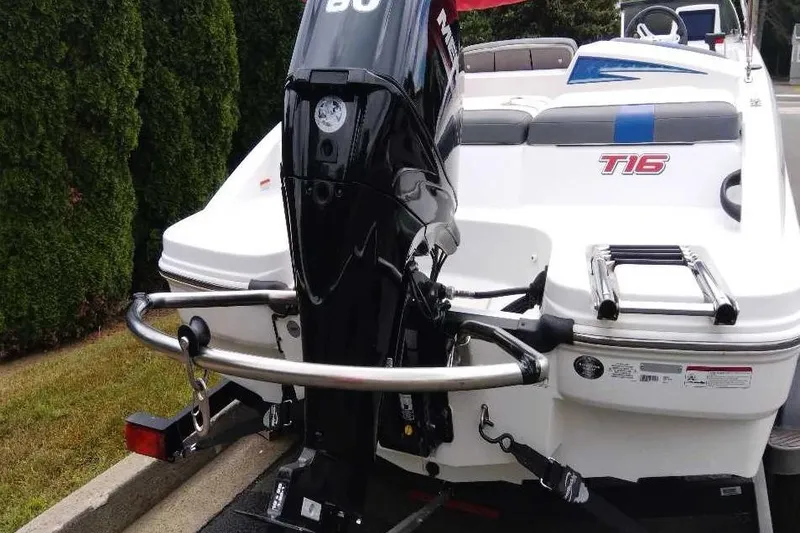 Slide: The Image of 2024 Tahoe T16 boat with outboard motor and rear seating area. - 2