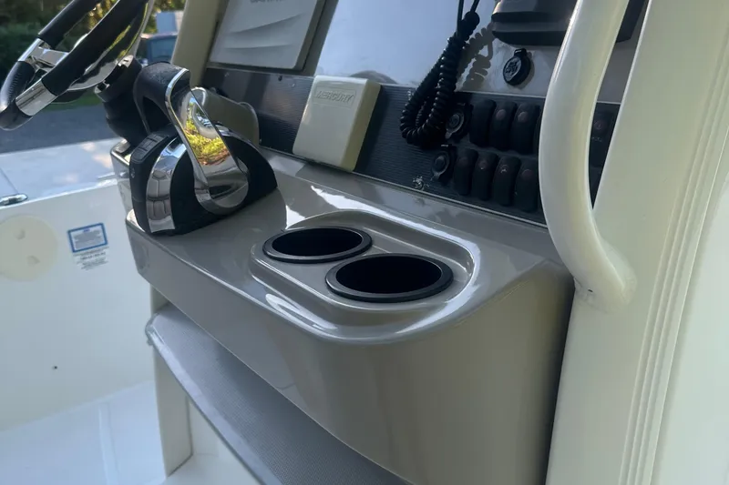 Slide: The Image of Control panel of a 2017 Boston Whaler 270 Dauntless boat with steering wheel and cup holders. - 10