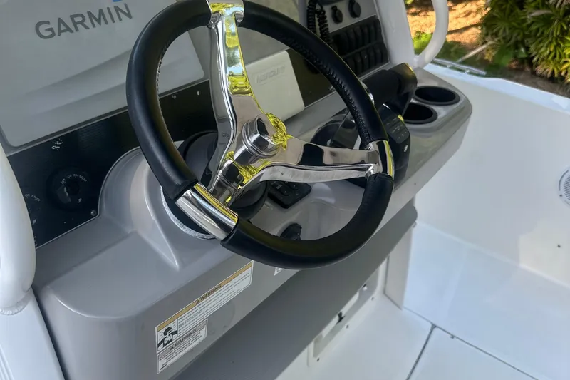 Slide: The Image of Steering wheel of 2017 Boston Whaler 270 Dauntless boat with Garmin navigation system. - 12