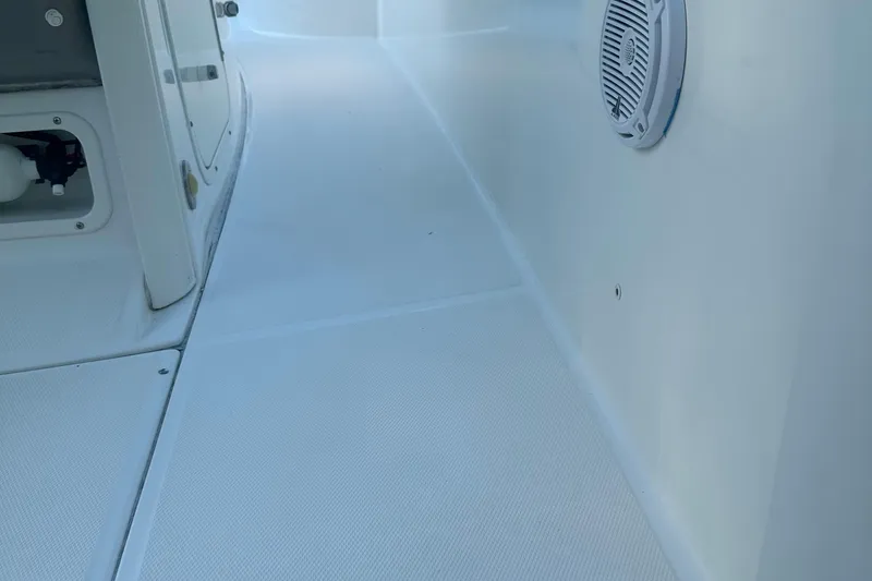 Slide: The Image of Interior view of a 2017 Boston Whaler 270 Dauntless boat, featuring clean white surfaces. - 25