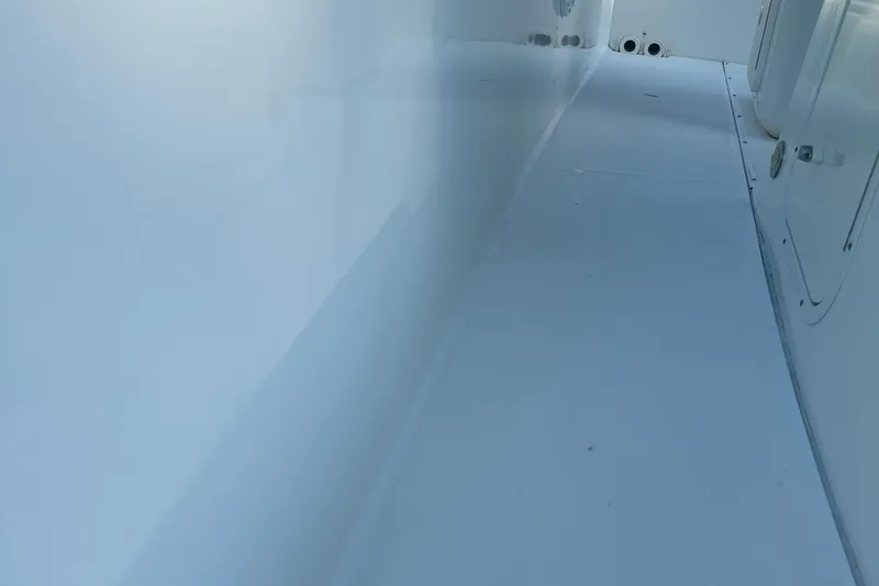 Slide: The Image of Interior view of a 2017 Boston Whaler 270 Dauntless boat, showcasing sleek white surfaces. - 27