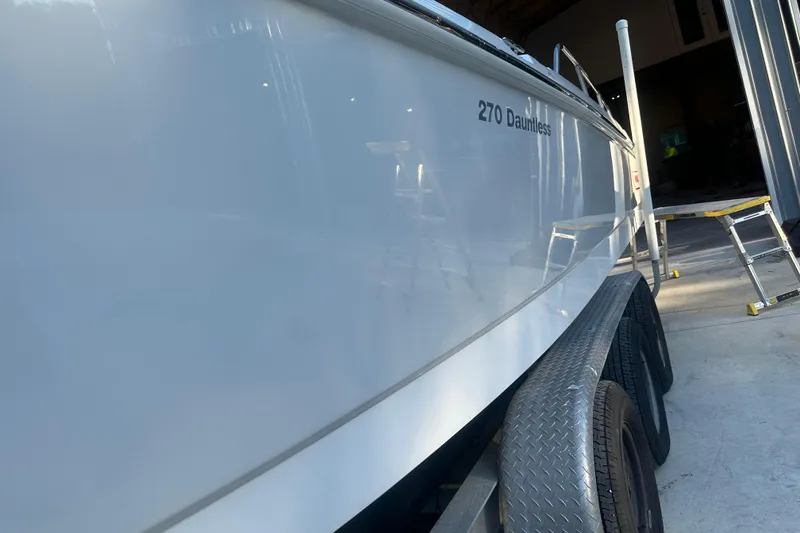 Slide: The Image of 2017 Boston Whaler 270 Dauntless boat on trailer in a garage. - 28
