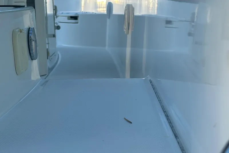 Slide: The Image of 2017 Boston Whaler 270 Dauntless interior, showcasing sleek white deck and side panel details. - 29