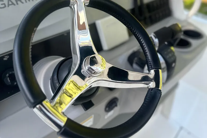 Slide: The Image of Steering wheel of a 2017 Boston Whaler 270 Dauntless boat, close-up view. - 3