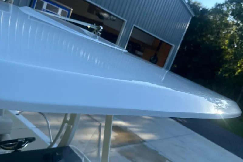 Slide: The Image of 2017 Boston Whaler 270 Dauntless boat detail near a garage. - 6