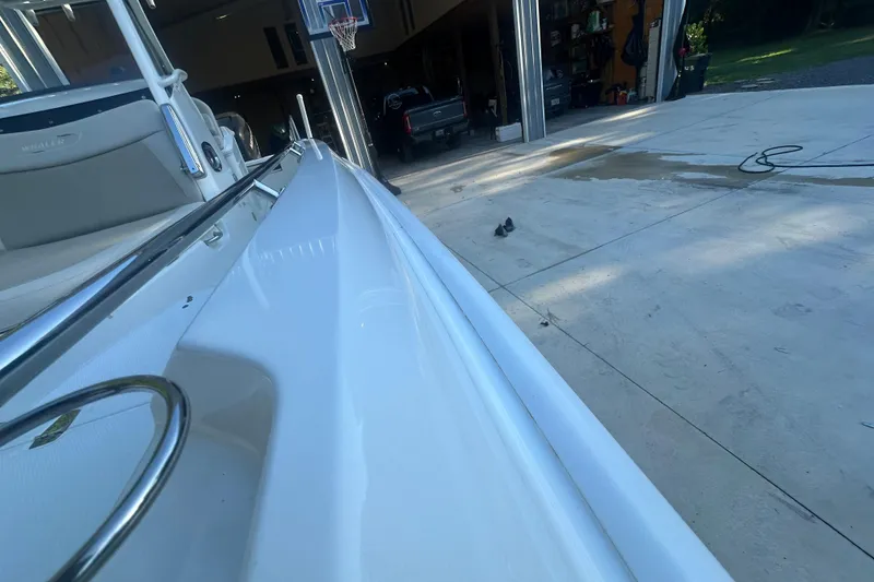 Slide: The Image of 2017 Boston Whaler 270 Dauntless boat parked near a garage with basketball hoop. - 7