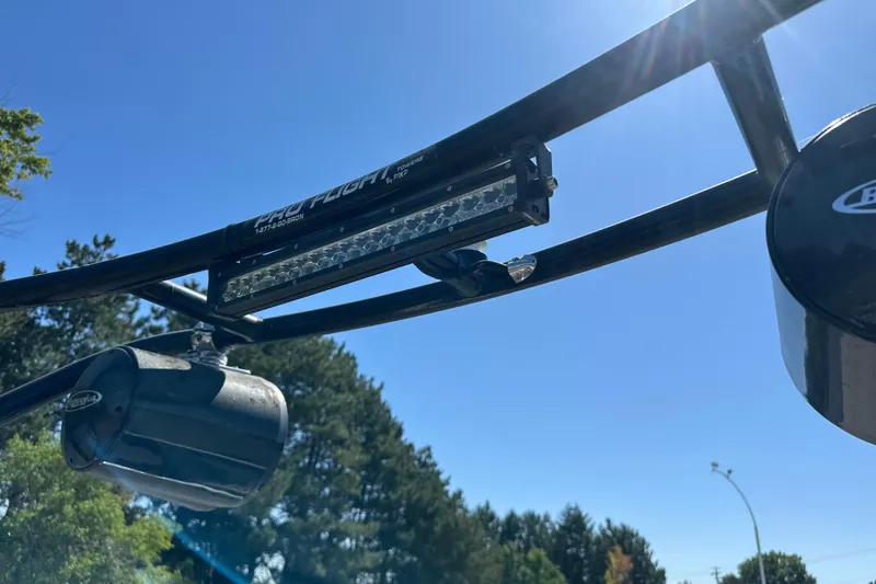 Slide: The Image of 2001 Centurion Elite Bowrider wakeboard tower with speakers and light bar under clear blue sky. - 11