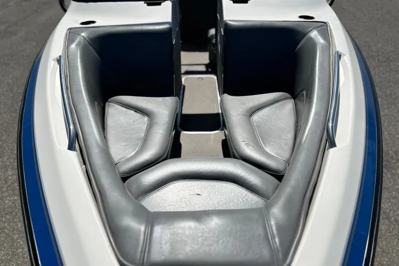 Slide: The Image of 2001 Centurion Elite Bowrider boat interior with gray seating and blue accents. - 5