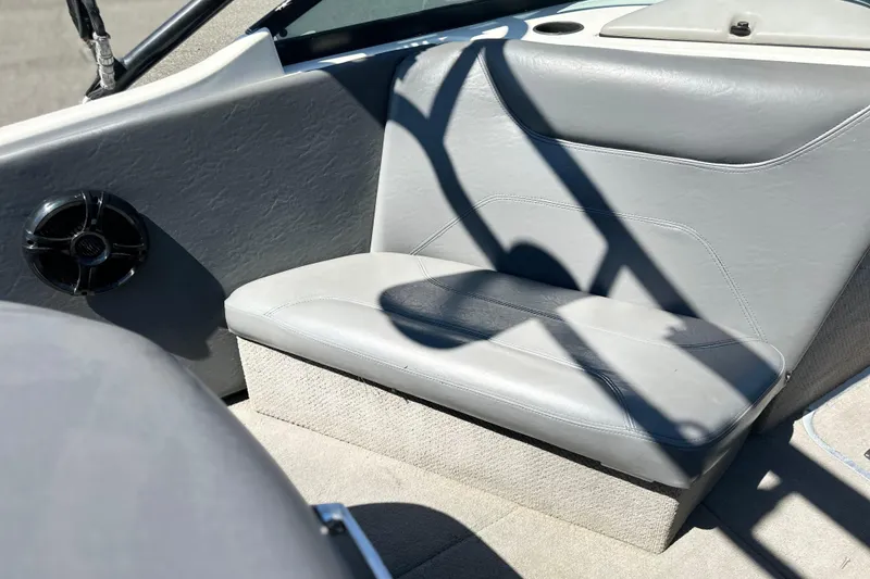 Slide: The Image of 2001 Centurion Elite Bowrider interior with gray seating and speaker detail. - 9