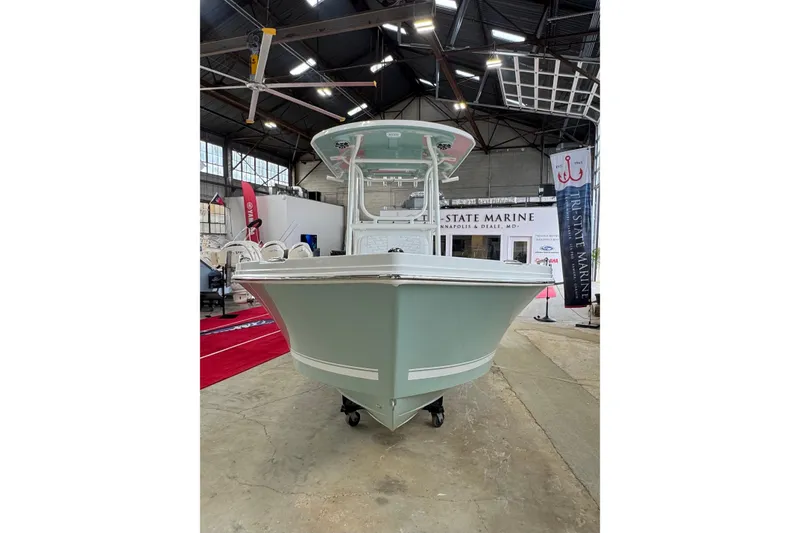 Slide: The Image of 2026 Parker 23SE Center Console boat displayed indoors at a marine exhibition. - 2