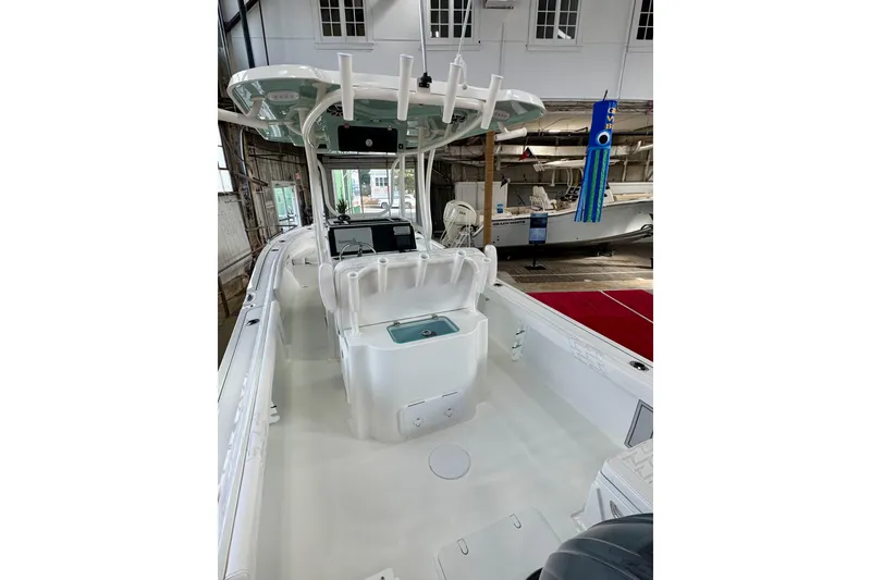 Slide: The Image of 2026 Parker 23SE Center Console boat interior in showroom, featuring modern design and equipment. - 4