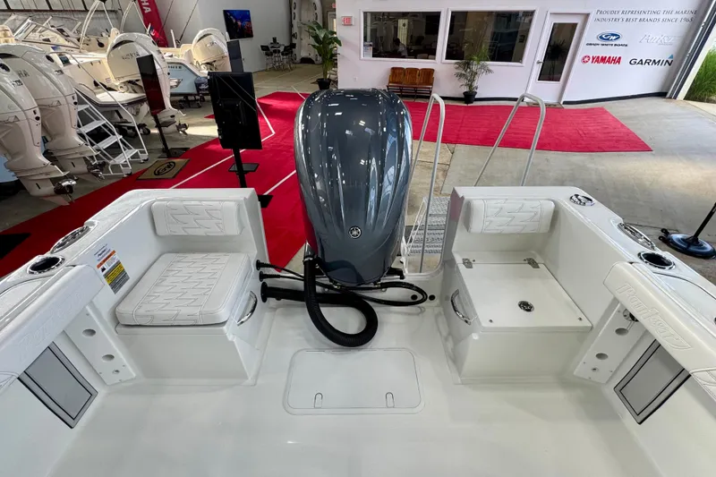 Slide: The Image of 2026 Parker 23SE Center Console boat interior with Yamaha engine in showroom. - 6
