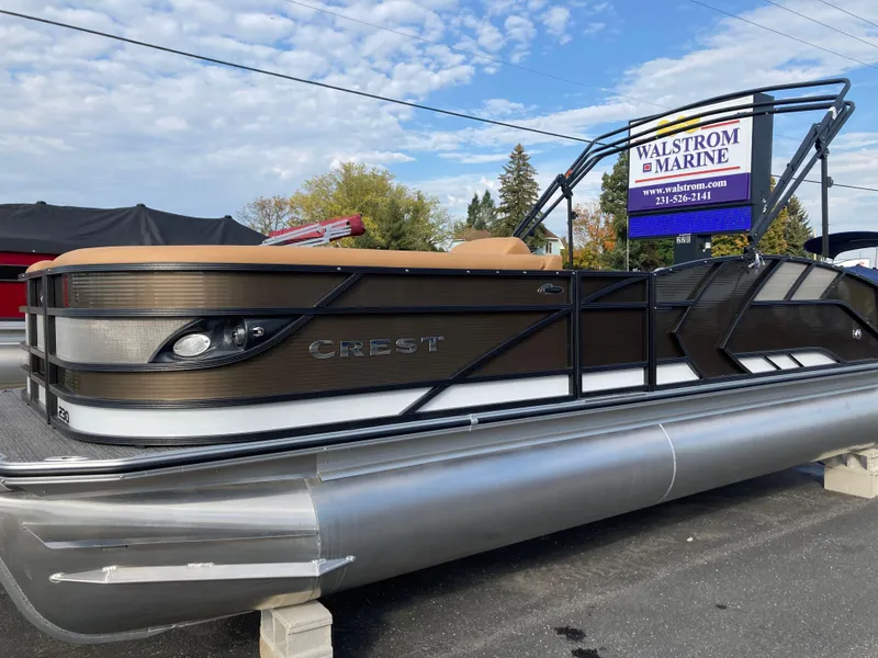 The Image of 2022 Crest Caribbean LX 230 SLS pontoon boat displayed at Walstrom Marine dealership. - 0