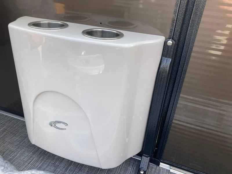 Slide: The Image of Cup holder on 2022 Crest Caribbean LX 230 SLS boat, featuring sleek design and dual compartments. - 10