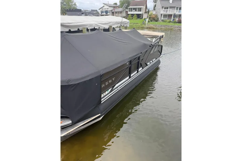 Slide: The Image of 2022 Crest Caribbean LX 230 SLS pontoon boat covered at dockside. - 19