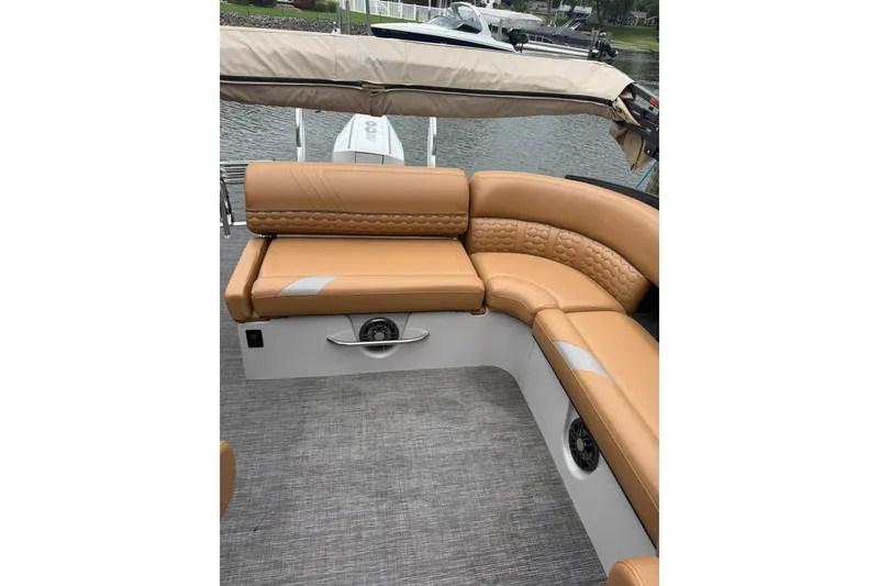 Slide: The Image of Luxurious seating on 2022 Crest Caribbean LX 230 SLS boat, featuring tan upholstery and sleek design. - 25