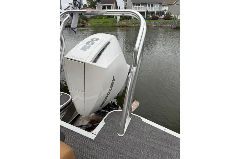 Slide: The Image of 2022 Crest Caribbean LX 230 SLS with Mercury outboard motor on a calm lake. - 29