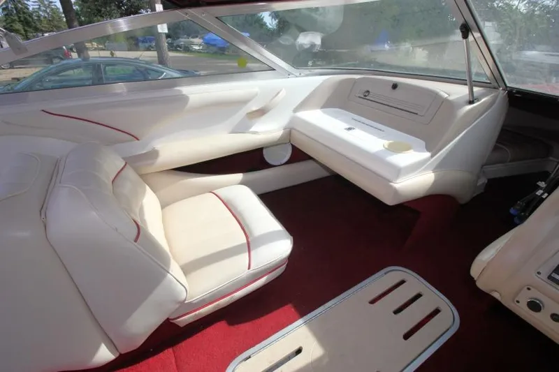 Slide: The Image of Interior of a 1994 Sea Ray 180 Bow Rider with white seating and red carpet. - 10