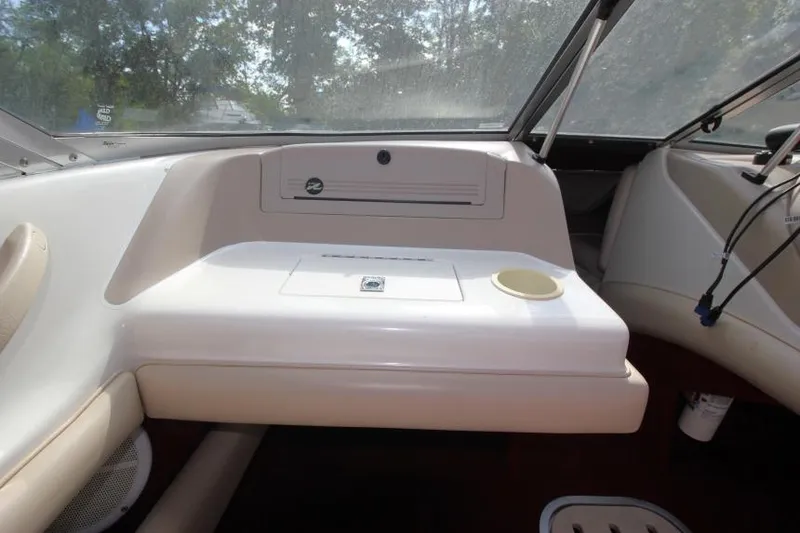 Slide: The Image of 1994 Sea Ray 180 Bow Rider dashboard with storage compartment and cup holder. - 12