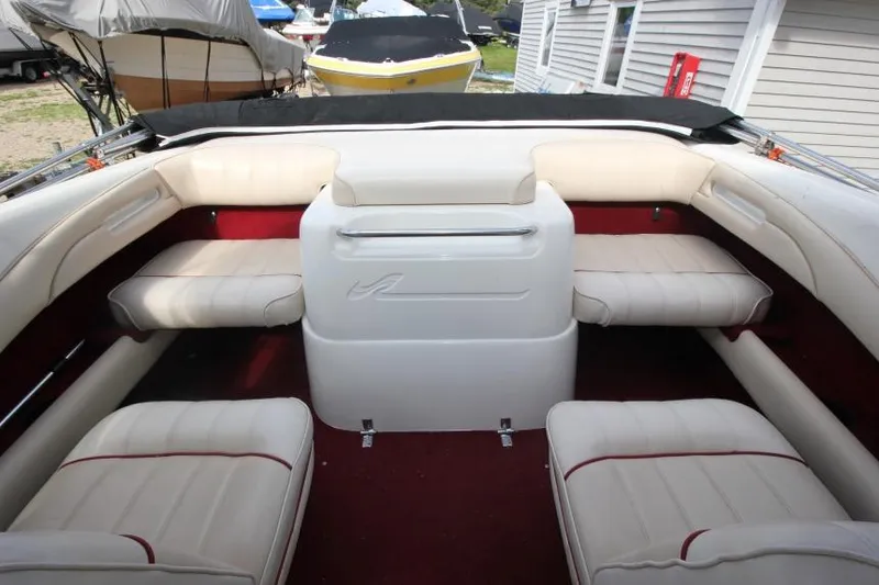 Slide: The Image of 1994 Sea Ray 180 Bow Rider interior with white seating and red carpet. - 13