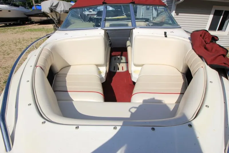 Slide: The Image of 1994 Sea Ray 180 Bow Rider boat with white seating and red accents. - 15